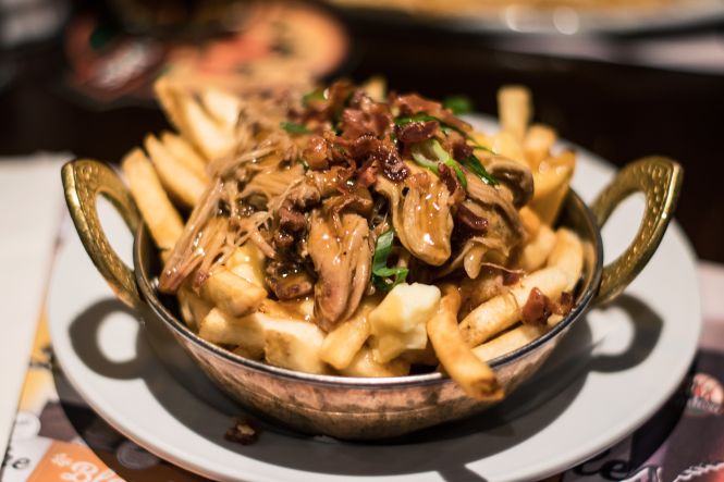 Not indulging in poutine while in Canada is like skipping the main event. Photo by 0x010C, licensed under CC BY-SA 4.0