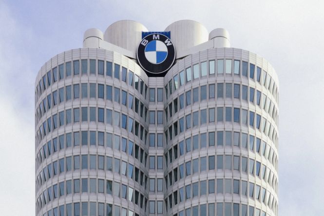 A very tall building with a BMW logo on it's side. Photo by Maksym Mazur on Unsplash