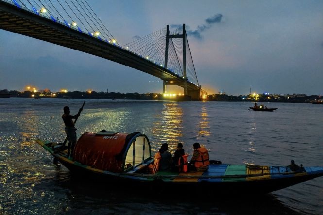 People on a boat in Kolkata. Photo by ABHISHEK CHAKRABORTY on Unsplash