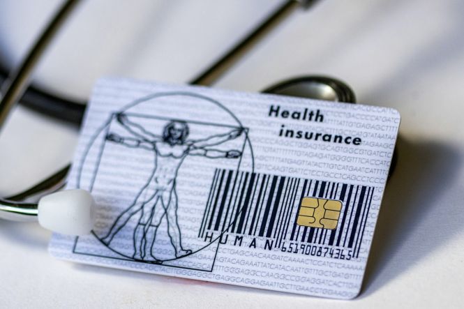 A health card and a stethoscope. Photo by Marek Studzinski on Unsplash