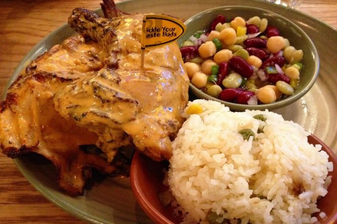 Flame-grilled PERi-PERi chicken. Photo by Banej, cropped from original. License: CC BY-SA 4.0