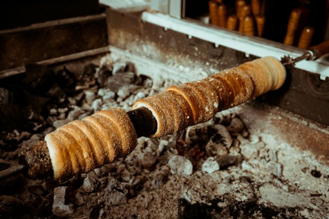 Trdelnik cooking over coals on the streets of Prague. Photo by Lisa Gageler on Unsplash