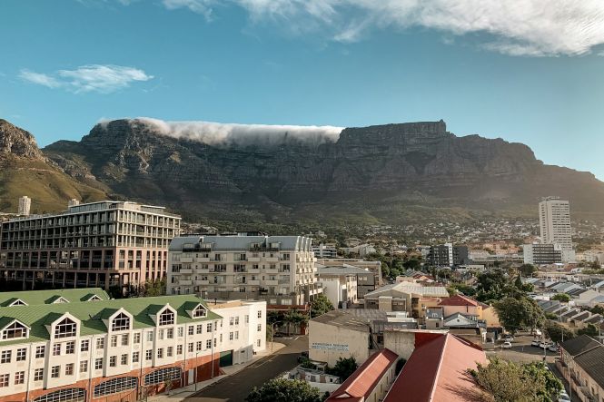 A summer sunset view of Cape Town's famous Table Mountain. Photo by Patrick Ward on Unsplash